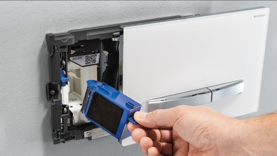 Hand installiert das Geberit DuoFresh Modul in der Betätigungsplatte an der Wand (© Geberit) Hand installiert das Geberit DuoFresh Modul in der Betätigungsplatte an der Wand (© Geberit)